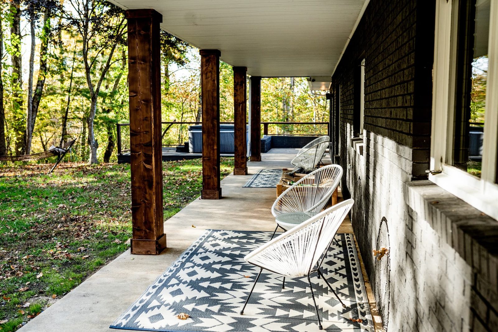Covered porch with forest views at Big Rock Falls farm near Asheville